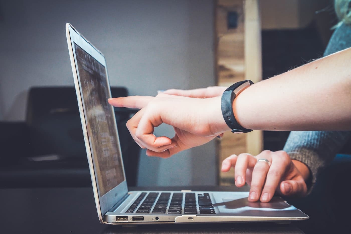 A tutor and student working through material together on a laptop